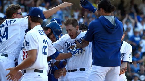 Yasmani Grandal es felicitado por el resto de los Dodgers tras pegar el cuadrangular del triunfo.