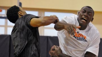 Gerald Henderson (izq.) y Bismarck Biyombo, jugadores de los Bobcats de Charlotte, pelean por un rebote en la práctica de ayer.