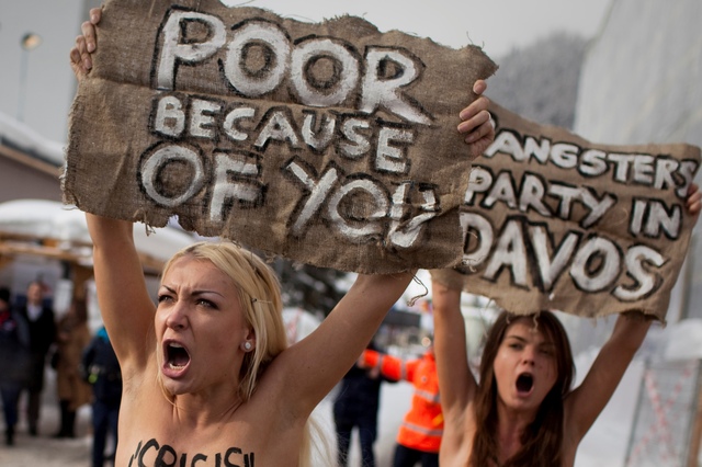 Foto de archivo. Con carteles que dicen: 'pobres por ustedes' y 'fiesta de gansters en Davos', manifestantes protestan en el Foro Económico Mundial.