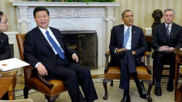 Xi  (izq), que se encuentra en Washington de  visita oficial,   defendió el historial de su país.