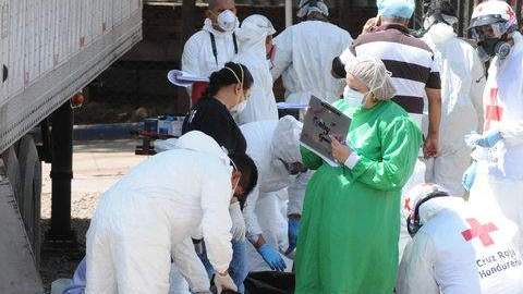 Médicos forenses examinan los cuerpos de los prisioneros fallecidos antes de entregarlos a sus familiares en Tegucigalpa, Honduras.