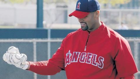 Albert Pujols aparta algunas bolas luego de su primera práctica de bateo en el Estadio Temple Diablo.