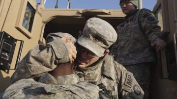 Soldados de la  Primera División de Caballería del ejército de EEUU se abrazan mientras se preparan para partir de la base Camp Ader.