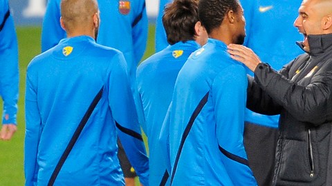 Guardiola (de negro) bromea con Keita en un descanso de la práctica de ayer del Barsa, que hoy va por su pase a cuartos de la Champions.