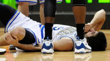 Ricky Rubio yace en el piso agarrándose la rodilla maltratada.