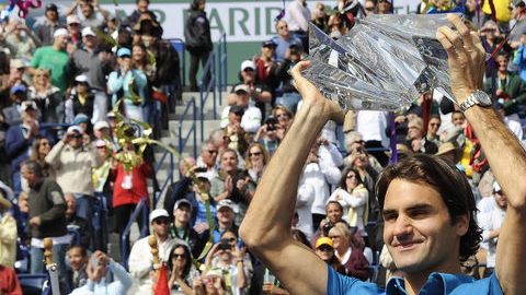 Roger Federer alza feliz  su trofeo agradeciendo la ovación de la concurrencia  que le aplaude de pie.