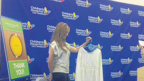 Cely Ledesma sostiene el vestido donado por Jenni Rivera (der.)