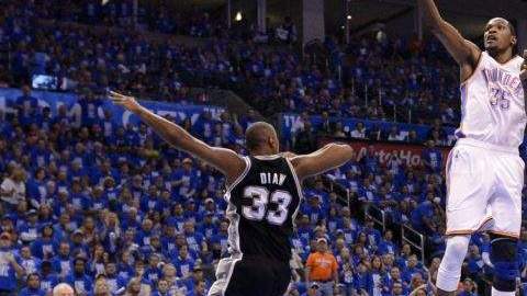 El jugador de los Thunder Kevin Durant (d) salta para encestar ante la marca de Boris Diaw (i) de los Spurs.