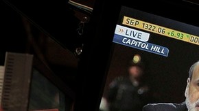 Un corredor de la Bolsa de NY escucha atentamente la alocución de Bernanke, el líder del Banco de la Reserva Federal.