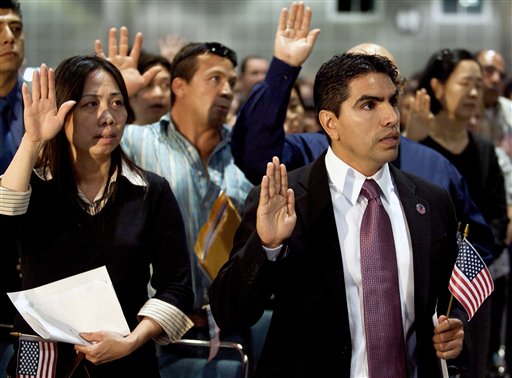 Eddie "Piolin" Sotelo, derecha, conductor de Univisión, toma juramento de naturalización como nuevo ciudadano de Estados Unidos en el Los Angeles Convention Center.
