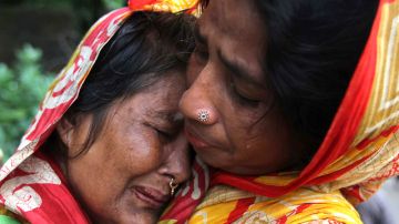 Una mujer de Bangladesh (izq.), cuyo familiar murió en uno de los deslaves, es consolada por otra, en Chittagong,  ayer.