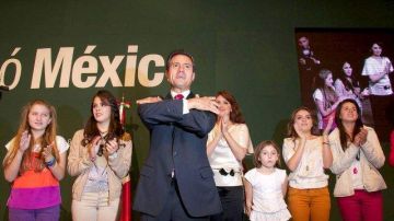 Enrique Peña Nieto al comenzar a celebrar la victoria anoche, mientras en la parte de atrás se observa a su esposa, la actriz Angélica "La Gaviota" Rivera y sus hijas.
