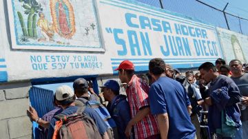 Migrants struggle to get free food in a Tijuana shelter.