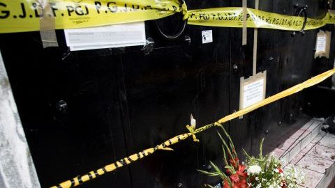 Policías en guardia junto a un altar en el club News Divine, donde 12 personas murieron en una estampida, el, 24 de junio de 2008.