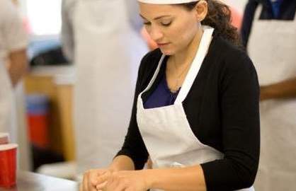 La científica puertorriqueña, Yajaira Sierra Sastre, cocina pan como parte de una demostracion.