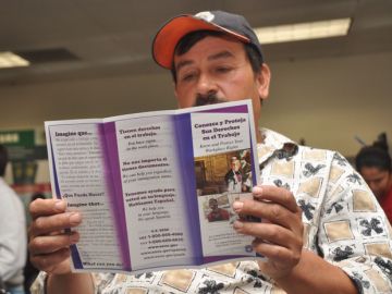 Armando Curiel, residente en San José, lee sus derechos como trabajador.