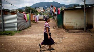 Una mujer camina por una calle sin asfaltar de Vista del Valle, a las afueras de Ciudad de Guatemala el jueves 30 de agosto de 2012.