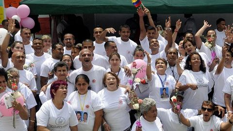 La Fundación Madres de la Candelaria posan junto a exparamilitares que se encuentran presos, en un acto en el que los convictos les pidieron perdón por haber atacado a sus hijos,  en Colombia.