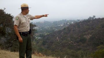 Fernando Gómez, jefe de guardabosques de la Autoridad de Recreación y Conservación de las Montañas, apunta a una colina.