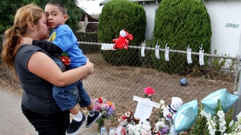 Stephanie Venegas con su hijo Nathan frente al altar  para las víctimas. Nathan y el niño fallecido eran compañeros de escuela.