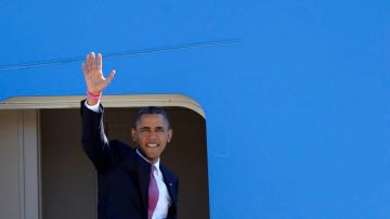 El Presidente Barack Obama saluda desde las escaleras del Air Force el 22 de octubre de 2012, cuando se preparaba para salir a a Boca Ratón, Florida.
