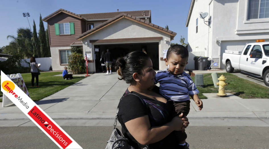 Yesenia Perez leaves a home which had been turned into a polling station with her 1-year-old son, Eduardo Sanchez, after voting in the Weston Ranch are of Stockton, Calif.