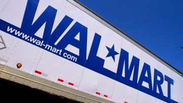 FILE - In this May 16, 2011 file photo, the Wal-Mart logo is displayed in Springfield, Ill. The world's largest retailer is throwing its doors open at 8 p.m. on Thanksgiving Day, two hours earlier than a year ago. It's also guaranteeing shoppers that it will have three of the most popular items it sells if they line up inside the store during a one-hour event that day. AP Photo/Seth Perlman, File)