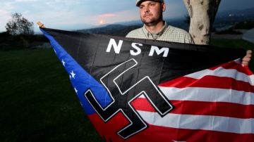 Jeff Hall con una bandera de un partido supremacista blanco en foto de 2010.  Su hjo lo mató cuando tenía apenas 10 años de edad.