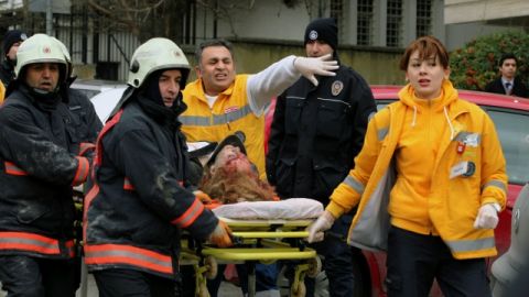 Paramédicos y bomberos llevan a una mujer herida en una camilla hacia una ambulancia después del ataque suicida que sufrió la embajada de los Estados Unidos en Ankara, Turquía, ayer.