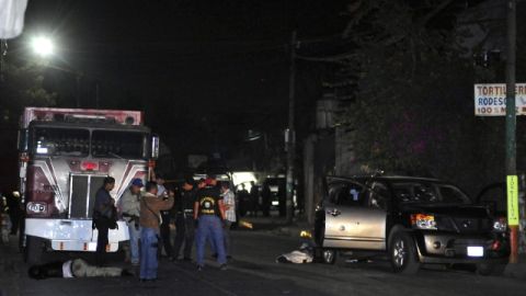 Peritos investigan el sitio donde tres escoltas del fiscal general del estado de Morelos, Rodrigo Dorantes Salgado, murieron.