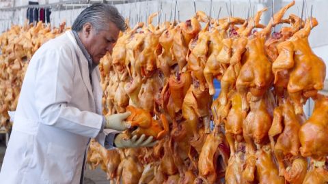 El director del Rastro de Aves de la ciudad mexicana de León, Óscar Ramos Rodríguez, examina algunas aves sacrificadas ayer.