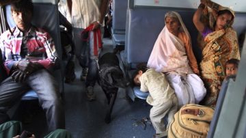 Policías indios revisan un tren con un perro rastreador en la estación de Bombai (India) ayer.