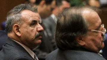 Former Bell, Calif. mayor Oscar Hernandez, left, and defendant Victor Bello, right listens to closing arguments in a massive city corruption trial in a downtown Los Angeles courtroom Wednesday, Feb. 20, 2013. The former mayor and vice mayor and four former city council members of the Los Angeles suburb of Bell are charged with misappropriation of public funds in a plot to line their own pockets at the expense of citizens.  Also on trial are former vice mayor Teresa Jacobo, and former council members, George Mirabal, George Cole,  and Luis Artiga. (AP Photo/Los Angeles Times, Irfan Khan, Pool)