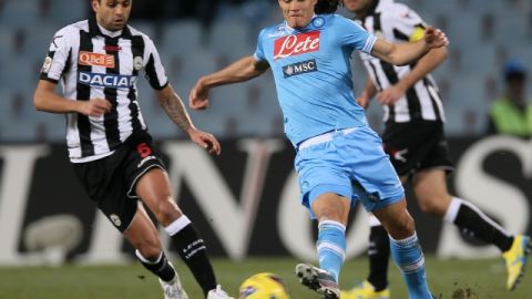 Edinson Cavani (centro), de Nápoles, maniobra entre los defensores del Udinese en el partido   disputado ayer en  el Estadio Friuli de Udine.