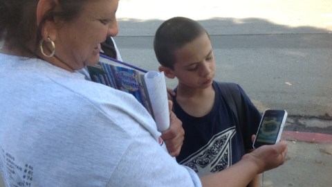 Luz Gutierrez y su hijo Marc Anthony, de la primaria Stanford Avenue en South Gate, miran los menús por el celular.
