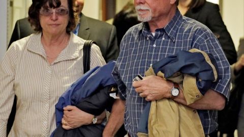Robert y Arlene Holmes llegan a la corte  para una audiencia de su hijo, sospechoso de matanza en el Teatro Aurora.
