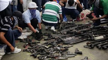 Pandilleros en la entrega de armas de fuego a las autoridades, en el municipio de Apopa, en El Salvador, que fue declarado como "municipio santuario".