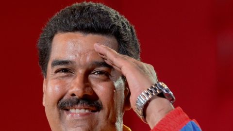 Venezuela's interim President Nicolas Maduro does a military salute to supporters during a campaign rally in Valencia. Venezuela, Thursday, April 4, 2013. The presidential election to replace Venezuela's late President Hugo Chavez is scheduled for April 14.  (AP Photo/Ariana Cubillos)