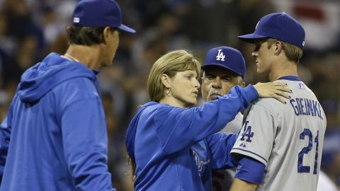 Greinke (21) es revisado tras la pelea que provocó con un pelotazo.