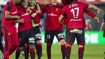 Dos Santos (segundo de izq. a der.) festeja con sus compañeros tras anotar ayer el valioso gol para el Mallorca.