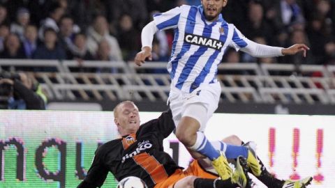 Carlos Vela, de Real Sociedad,  supera al defensor Jeremy Mathieu, del Valencia, en un lance del partido de ayer por la Liga Española.