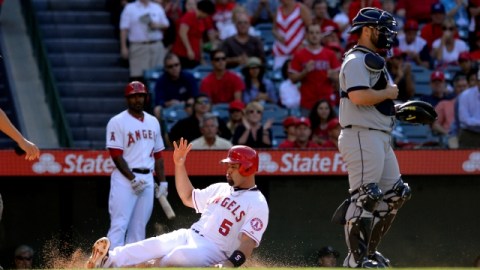 Albert Pujols (5), de Angels, se barre a tiempo en home para anotar tras imparable de Josh Hamilton.