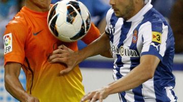 El chileno Alexis Sánchez (izq.), quien aquí lucha por el balón con Javi López, del Espanyol, marcó el 1-0 ayer para el Barcelona.