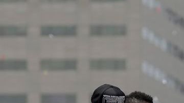 El jugador de los Miami Heat, Chris Bosh, junsto a sus compañeros de equipo, sostiene el trofeo del campeonato de la NBA durante el desfile por las calles de Miami.