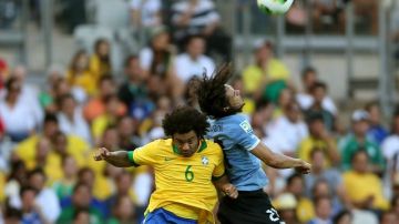 El defensa de la selección de Brasil, Marcelo Vieira (i), salta por el balón con Edinson Cavani, delantero de Uruguay