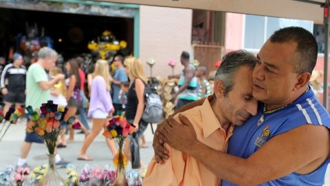 Walter Estrada (der.), un vendedor en el malecón, consuela a Mustafa Blace, atropellado junto a otros peatones en Venice, el pasado sábado.