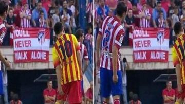 En la imagen se observa como Diego Godín hace señas a sus compañeros, indicando la parte donde Messi se encuentra lesionado