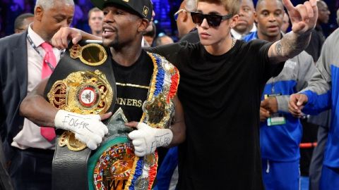 Floyd Mayweather Jr., left, poses for photos with Justin Bieber after defeating Canelo Alvarez during a 152-pound title fight, Saturday, Sept. 14, 2013, in Las Vegas. (AP Photo/Mark J. Terrill)
