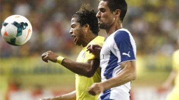 El jugador mexicano del Villarreal Giovani (i) pelea un balón con Raúl Rodríguez, del RCD Espanyol