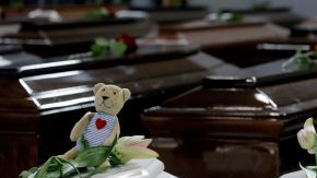 Varios féretros de víctimas del naufragio de Lampedusa yacen en el hangar del aeropuerto de esa región italiana.
